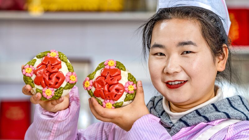 Artisan crafts steamed dough figurines for festive markets